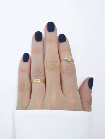 jewelry for this moment. the now.  a prominent 14K gold bar ring embossed with the now logo serves as a playful reminder to always raise the bar.